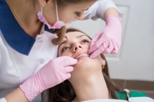 Orthodontist Examining Braces During Treatment